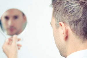43277081 - ego business man looking in the mirror and reflecting